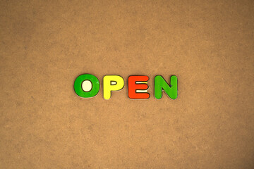 the word open from the wooden alphabet toy on the board