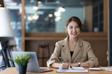 Portrait of an attractive smiling Asian businesswoman happy in the office.