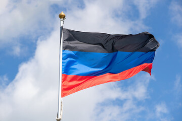 Flags of Russia, Donetsk People's Republic. The Donetsk and People's Republics are partially recognized state entities in Eastern Europe. Flag against the blue sky