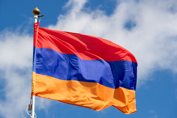The flag of Armenia in the beautiful sky flutters the fabric of the national flag of Armenia. Great for news. Flag of Armenia for advertising, celebration, achievements, festival, elections.