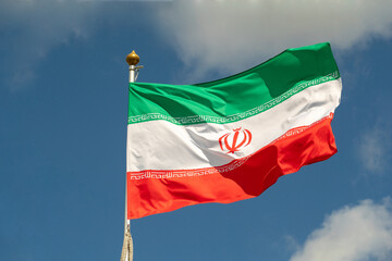 Naklejka na ściany i meble Iranian flag for advertising, celebration, achievements, festivals, elections. The Iranian flag flutters in the beautiful sky. Great for news.