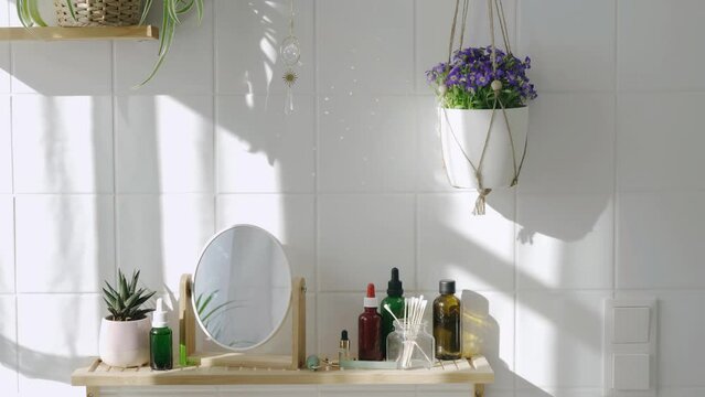 Sun catcher crystal making many sum beams and light spots on white tile wall at sunny day. Modern eco friendly bathroom with minimalistic biophilic design. Camera zoom in. 4K UHD