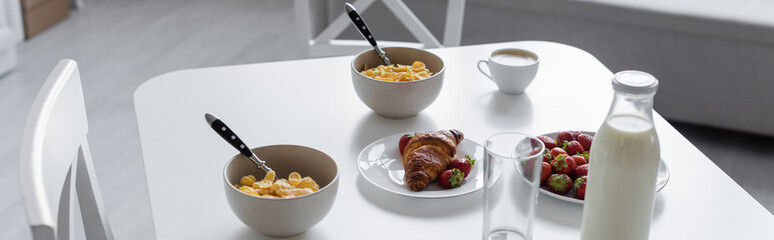 high angle view of tasty breakfast near beverages on kitchen table, banner.