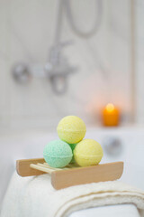 Natural cosmetics. Close-up of handmade bath bombs in bathroom. Concept of therapy. I'm taking relaxing bath. Homemade spa products. Vertical photo