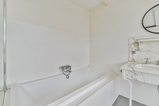 Light bathroom interior design with marble elements