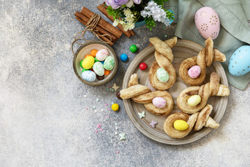 Easter rabbit-shaped buns puff pastry with  cinnamon on a stone tabletop. Easter bake idea. View...