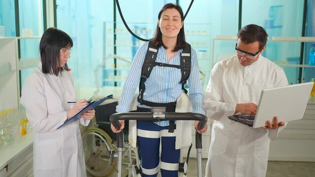 Portrait Of A Smiling Patient With Musculoskeletal Problems In A Medical Exoskeleton Walking Uses Running Machine