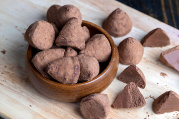 Cut into pieces truffle candy on a board