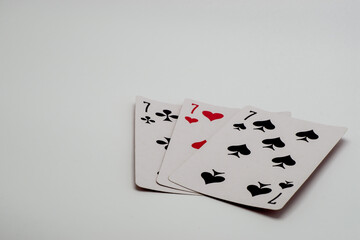 three playing cards on a white