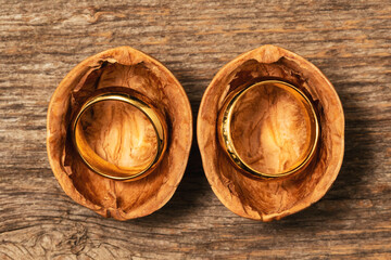 Opened walnut shell with a golden wedding rings