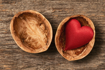 Red heart in a cracked walnut shell