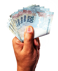 100 reais banknotes of Brazil held by male hand on isolated white background.