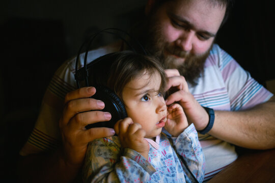 Father and daughter listening to music