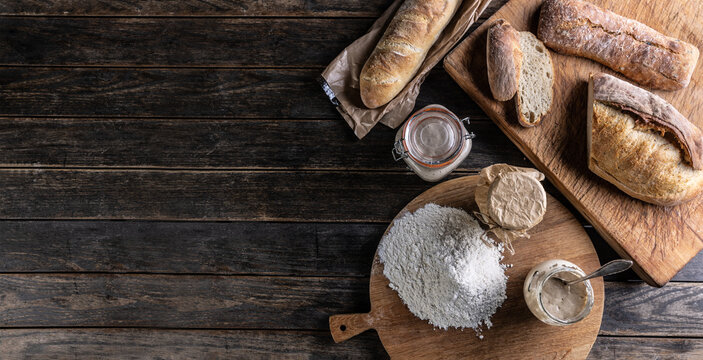 Bakery concept, flour bread and glasses with rye sourdough on the table. - Top of view