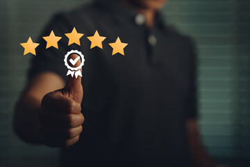 Customer satisfaction concept, business man thumbs up for five star rating. With positive emotions, to represent the highest level of service satisfaction, the star icon has a smiley emoticon.