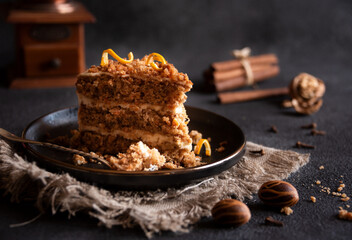 Piece of homemade cake with cinnamon on black plate