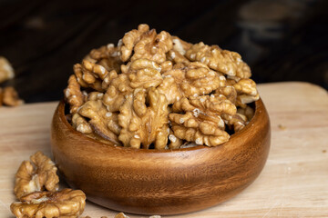 Peeled walnuts on a wooden surface