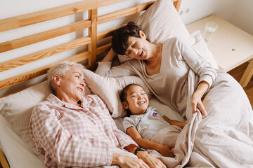 Obraz premium Happy mature same sex couple with adopted asian little girl