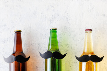 Bottle of beer with moustache. Movember. Concept of father's day, bachelor party.