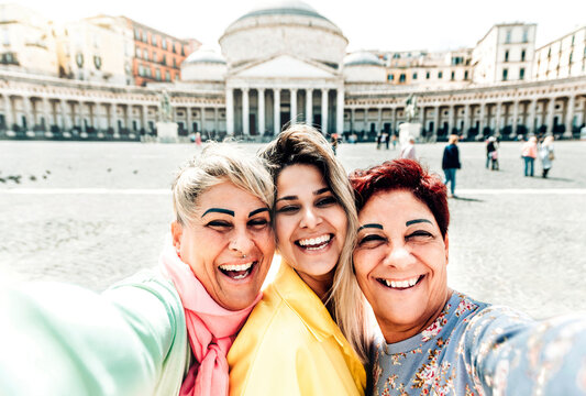 Girl mom and grandmother taking a selfie portrait in Plebiscite Square Naples - Happy family having fun at travel in Italy on spring - Holidays traveling and escursion lifestyle concept