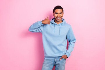 Portrait of positive guy toothy smile demonstrate thumb up isolated on pink color background