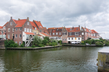 View of the historic harbor with its characteristic houses of Enkhuizen, the Netherlands.