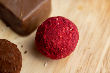 Red sweet candy in the shape of a ball on the table
