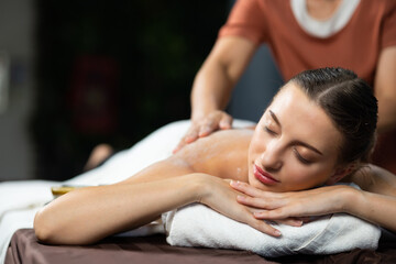 Obraz na płótnie Canvas Back spa massage. Beautiful cuacasian female getting massage in beauty spa and wellness center. Facial treatment and skin care concept.