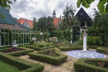 Traditional Dutch garden in a regular style with garden historical sculptures.