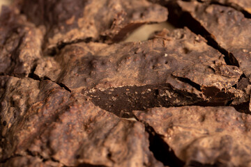 Pieces of chocolate with added cocoa and sugar