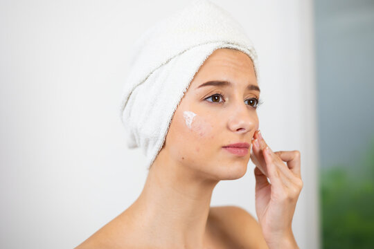 women's daily routine. Beautiful caucasian young woman removing makeup and cleaning from her face isolated on white background