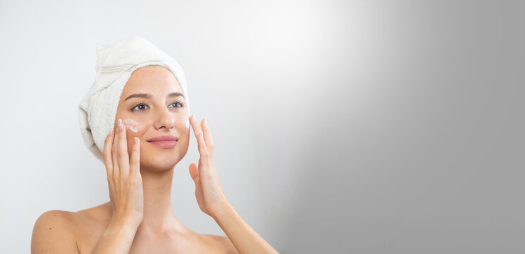 women's daily routine. Beautiful caucasian young woman removing makeup and cleaning from her face isolated on white background