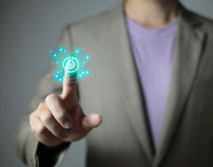 businessman pressing power button over computer. Start or shut down concept