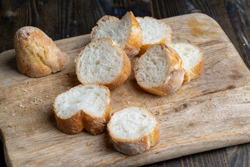 Sliced wheat baguette on a board