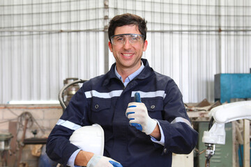 Engineer wearing safety goggles standing safety helmet in industrial plants.