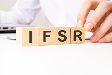 IFSR - Insurance Financial Strength Rating - acronym on wooden cubes on a white background