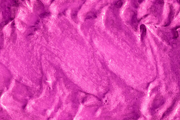 Smears of liquid purple magenta gel texture background. Smeared oil paint with pearly shine. Cream...