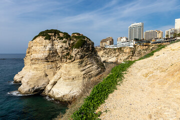 Obraz premium Raouche Rocks in Beirut, Lebanon in the sea during daytime. Pigeon Rocks in Mediterranean Sea. Popular Tourist Destination in Beirut. 