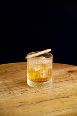 old fashion cocktail with cigarillo garnish