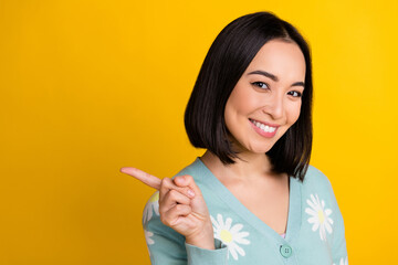 Photo of lovely cute glad lady wear stylish clothes arm presenting empty space news opening boutique isolated on yellow color background