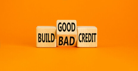Build good or bad credit symbol. Concept word Build good or bad credit on wooden cubes. Beautiful orange table orange background. Business and build good or bad credit concept. Copy space.