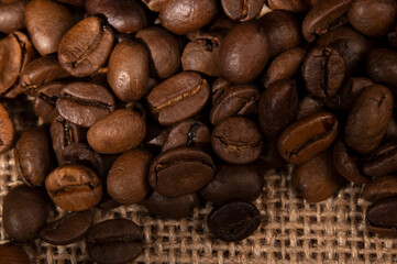 Coffee beans spilled out of the jar onto the table in the kitchen 
