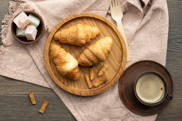 Coffee, croissants and Turkish delight on the table in the kitchen
