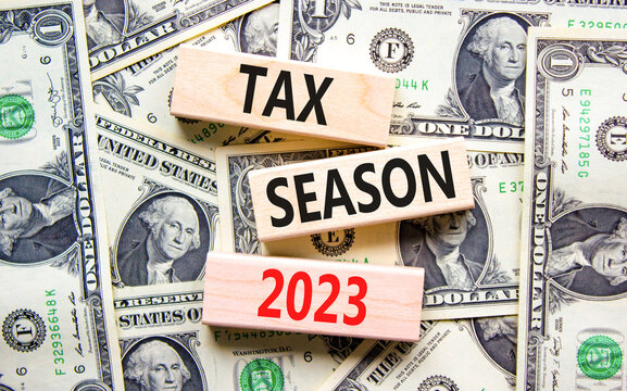 Tax Season 2023 Symbol. Concept Words Tax Season 2023 On Wooden Blocks On A Beautiful Background From Dollar Bills. Business Tax Season 2023 Concept. Copy Space.