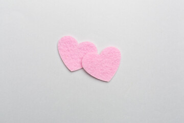 Felt hearts on color background, top view