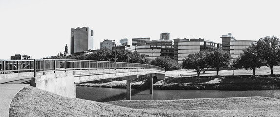 Fort Worth city skyline and buildings in black and white photography over the Trinity River Park Bridge in Texas