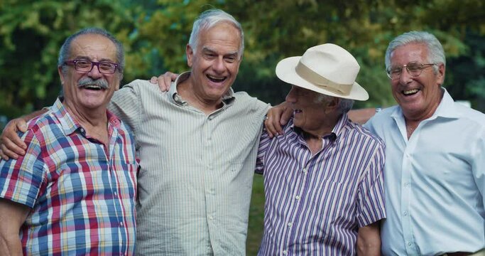 Portrait of a Group of Smiling and Active Senior Men Looking at the Camera Together in a Green Park. Positive Elderly Friends Posing for a Photo to Keep Their Happy Reunion Memory Alive. 