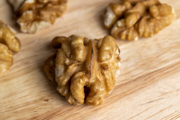 Peeled walnuts on a wooden surface