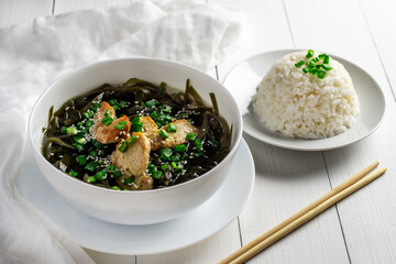 Korean seaweed soup with meat in a white bowl and boiled rice. Birthday soup. Traditional Korean cuisine. Healthy Eating. Pregnancy. Custom.