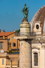 Fototapeta na wymiar Statue of Saint Peter on top of Trajan's Column in Rome, Italy